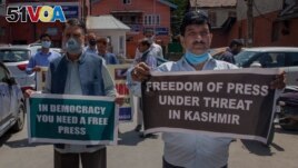 Kashmiri journalists hold placards during a protest against a new media policy that was announced last month in Srinagar, Indian controlled Kashmir, July 6, 2020.