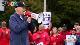 U.S. President Joe Biden joins striking United Auto Workers on the picket line, in Van Buren Township, Michigan on Sept. 26, 2023. (AP Photo/Evan Vucci)