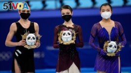 From left, silver medalist, Alexandra Trusova, of the Russian Olympic Committee (ROC), gold medalist, Anna Shcherbakova, of the ROC, and bronze medalist, Kaori Sakamoto, of Japan, pose after the women's figure skating competition at the 2022 Winter Olympi