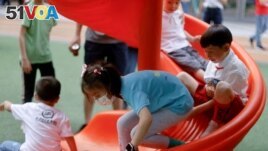 FILE - Children at a playground inside a shopping complex in Shanghai, China, June 1, 2021.