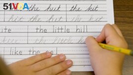 FILE - Students practice printing and cursive handwriting at the Mountaineer Montessori School in Charleston, WV., Sept. 2009. (AP Photo/Bob Bird)