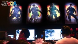 FILE - Gamers play Call of Duty: Black Ops 4 at a community reveal event in Hawthorne, California, May 17, 2018.