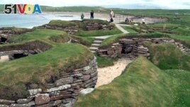 FILE - Visitors look at the ancient remains of Skara Brae village in the Scottish Orkney Islands, July 19, 2005. Officials on Scotland's Orkney Islands are considering options for 