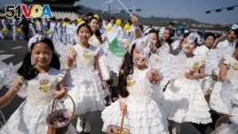 FILE - Children dressed as angels march during an Easter parade in Seoul, South Korea, on April 9, 2023. (AP Photo/Lee Jin-man, File)