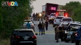 Police and other first responders say dozens of people have been found dead and multiple others were taken to hospitals with heat-related illnesses after a semitrailer containing suspected migrants was found, Monday, June 27, 2022, in San Antonio. (AP Photo/Eric Gay)