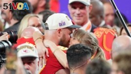 Travis Kelce kisses Taylor Swift after the Kansas City Chiefs' Super Bowl win on February 11.