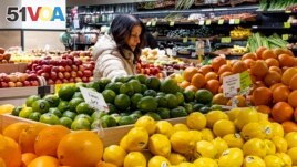 A woman browses produce for sale at a Whole Foods grocery store, Friday, Jan. 19, 2024, in New York. (AP Photo/Peter K. Afriyie)