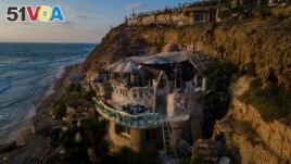 Nissim Kahlon's home, chiseled out of the sandstone cliffs, overlooks the Mediterranean sea in Herzliya, Israel, Wednesday, June 28, 2023. (AP Photo/Ariel Schalit)