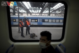 Police guard a train station during a government-ordered lockdown to curb the spread of the new coronavirus, in Buenos Aires, Argentina, Friday, April 24, 2020. (AP Photo/Natacha Pisarenko)