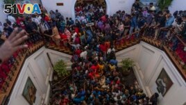 People occupy President Gotabaya Rajapaksa's official home for the second day in Colombo, Sri Lanka, Monday, July 11, 2022. (AP Photo/Rafiq Maqbool)