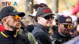 FILE - People identifying themselves as members of the Proud Boys joined a march on Nov. 14, 2020, in Washington. The gunman who killed eight people on Saturday, May 6, 2023, at a Dallas-area mall was also wearing a 
