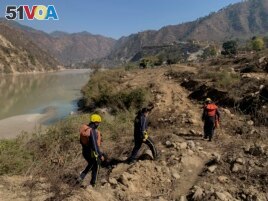 Rescuers arrive to search for bodies in the downstream of Alaknanda River in Rudraprayag, northern state of Uttarakhand, India, Monday, Feb.8, 2021.