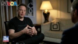 In this image released by FOX News, Elon Musk gestures as he is interviewed by FOX News host Tucker Carlson on Thursday, April 13, 2023. (FOX News via AP)