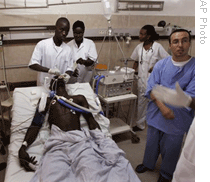 Medical workers in Dakar, Senegal, treat a patient with malaria 