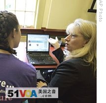 Anne McNeil (right) with IBM Corporate Community Relations, shows the World Community Grid to a student at Meredith College in North Carolina 