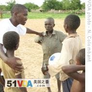 Aime Baligizi teaches children to play soccer