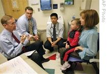 Medical student Sean Prater, second from left, listens as Doctor Wesley Burks talks to a patient at Duke South Clinic in Durham, North Carolina