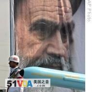 An Iranian military member by a picture of the revolutionary founder, Ayatollah Khomeini near Tehran (file photo)