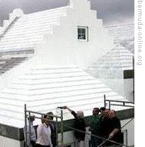 A new roof in Bermuda is completed with a roof-wetting ceremony. Many roofs on the island are painted white.