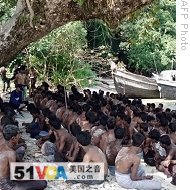 This undated handout photo released by Thai Royal Navy on January 18, 2009 shows illegal immigrants from Bangladesh and Burma after they were escorted by Thai navy to Similan island  