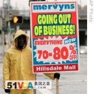 Joe Smith holds a sign adverting a going out of business sale at the Hillsdale Shopping Center in San Mateo , California (File)  