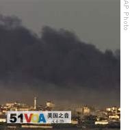 Smoke rises from Israeli bombardment over Gaza City as seen from Israel's border with Gaza, 12 Jan 2009