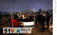 Jordanian demonstrators hold a Palestinian flag during a protest near the Israeli embassy in Amman, 30 Dec 2008