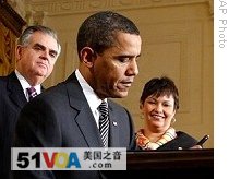 President Barack Obama, flanked by Transportation Secretary Ray LaHood, left, and EPA Administrator Lisa Jackson, signs executive order dealing with energy independence and climate change at the White House, 26 Jan. 2009
