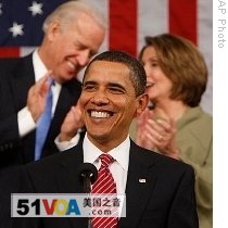 Vice President Joe Biden and House Speaker Nancy Pelosi talk behind President Barack Obama during his address to a joint session of Congress, 24 Feb 2009