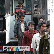 Rohingya migrants walk out a police van after arriving at Ranong provincial court to hear charge of illegal entry in Ranong province, southwestern Thailand, 28 Jan 2009