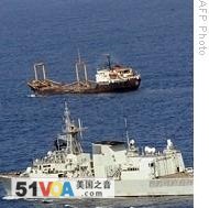 A Canadian Navy warship, foreground, escorts a World Food Program ship off the coast of Somalia (file photo)