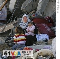 A Palestinian woman sits in the rubble of her home in the eastern area of Jebaliya after Israeli troops withdrew from the northern Gaza Strip, Sunday, 18 Jan. 2009