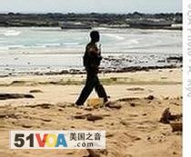 A pirate taking a stroll on shore in Hobyo, Somalia, (2008 file photo)