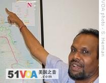Lakashman Hulugalle, director general, Media Center for National Security, points to location on map of remaining LTTE rebel-held territory