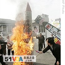 South Korean protesters burn North Korean flags with portraits of North leader Kim Jong Il and mock missiles in Seoul, South Korea, 03 Apr 2009