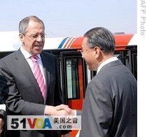 Russian Foreign Minister Sergei Lavrov, left, shakes hands with North Korean vice Foreign Minister Kung Sok Ung upon arrival in Pyongyang, 23 Apr 2009