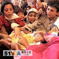 Children displaced from fighting in Swat Valley gather for meal in Jalozai camp on outskirts of Peshawar, 15 May 2009