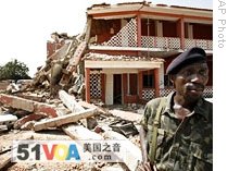 A soldier stands outside a collapsed section of the military HQ in Bissau where a bomb killed the armed forces chief of staff, 03 Mar 2009