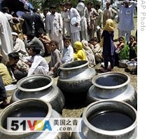 Pakistanis fleeing troubled Swat valley wait for food in a camp set up in Mardan near Peshawar, 06 May 6 2009