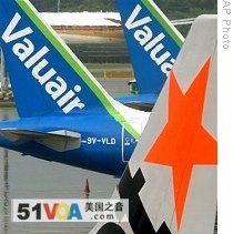 Tail of a Jetstar Asia plane is seen in the foreground as it steers pass two Valuair planes at the Changi International Airport in Singapore (File)<br />