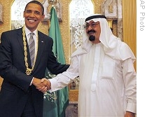 President Barack Obama (L) shakes hands with Saudi King Abdullah bin Abdul Aziz al-Saud after being presented with Order of Merit during bilateral meeting at king's ranch in al-Janadriya, 03 Jun 2009
