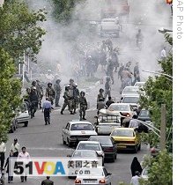 Riot police in front of cloud of tear gas as supporters of Mir Hossein Mousavi clash with police in Tehran, 13 Jun 2009