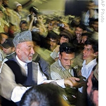 Presidential candidate and current Pres. Hamid Karzai (L) greets supporters at an election rally in Kabul, 24 Jul 2009
