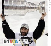 Pittsburgh Penguins' Bill Guerin raises the Stanley Cup after the Penguins won the National Hockey League championship in June