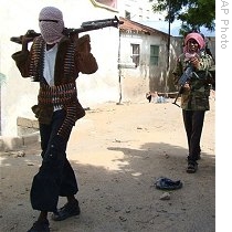 Somali Islamist militants carry their weapons as they patrol the streets of northern Mogadishu (File)