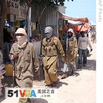 Armed Al-Shabaab fighters patrol Bakara Market in Mogadishu, Somalia, 29 Jun 2009