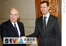 U.S. Mideast envoy George Mitchell, left, shakes hands with Syrian President Bashar Assad, upon his arrival at the Syrian presidential palace, in Damascus, Syria, on Sunday, July 26, 2009 