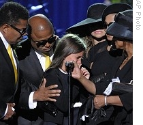 Paris Jackson is supported by her family after speaking about her father during the memorial service for Michael Jackson at the Staples Center in Los Angeles, 7 July  2009