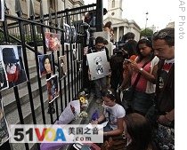 Fans of Michael Jackson bring flowers, pictures and candles at a makeshift memorial shrine in central London's Trafalgar Square, 26 June 2009