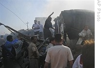 People gather at the site of a car bomb attack in Kirkuk, Iraq, Tuesday, 30 June 2009